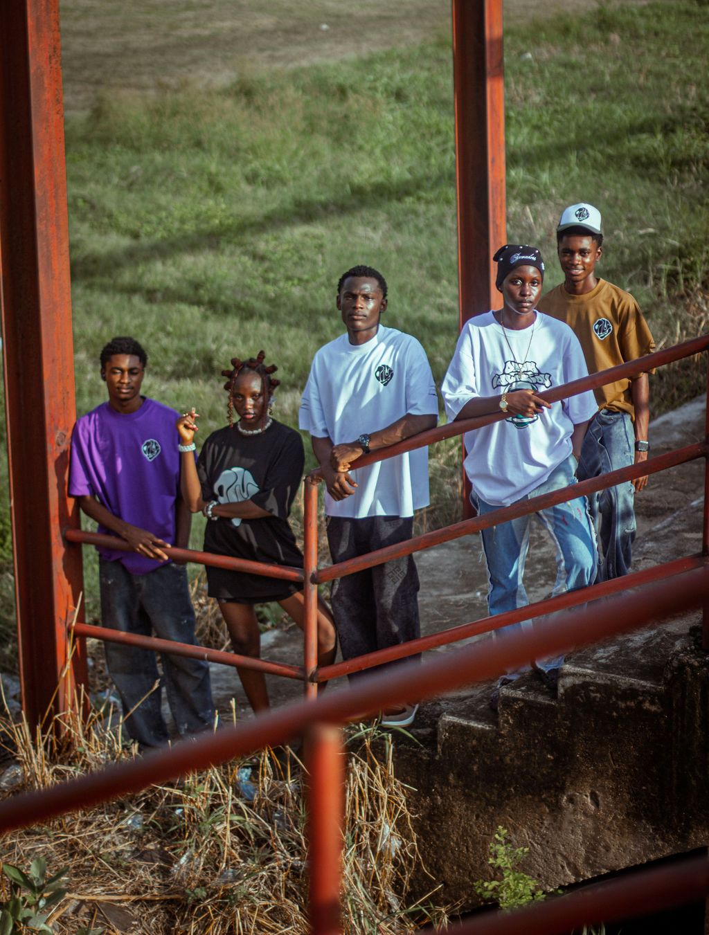 A group of creatives gathered along a railing at a T21 event